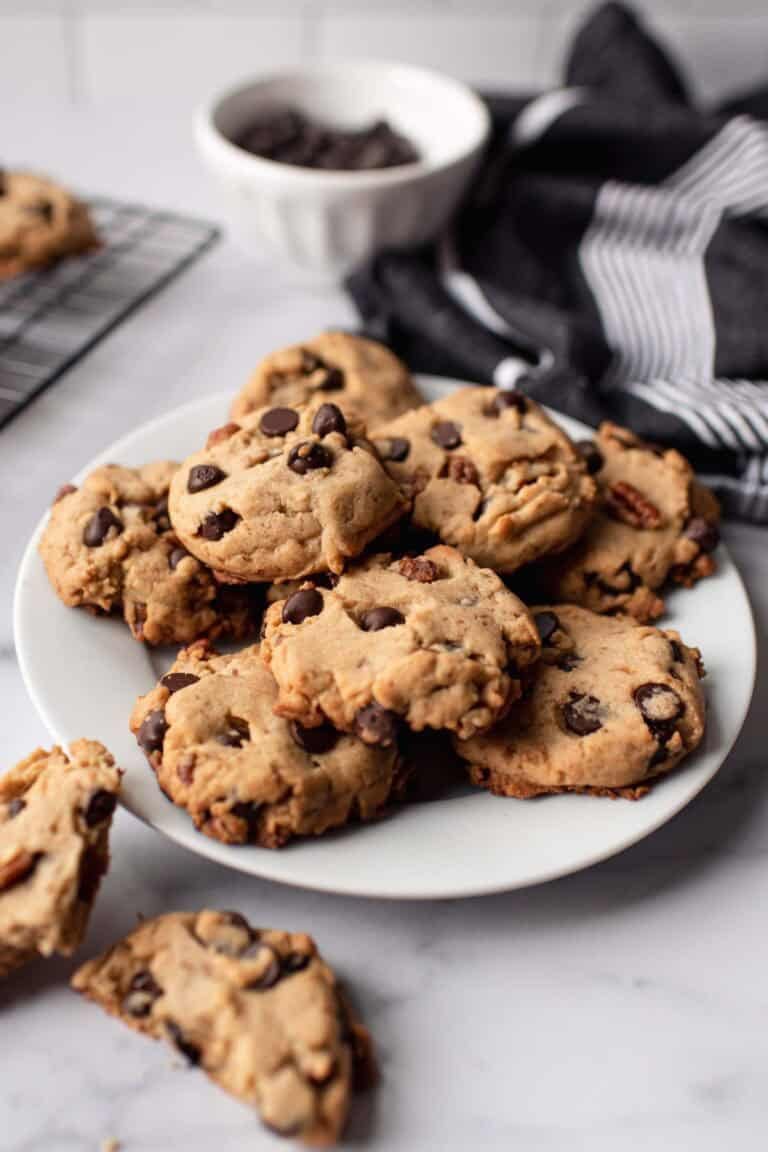 Chocolate chip cookies with nuts on a plate.