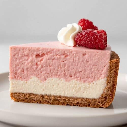 Layered cheesecake with raspberry mousse and graham cracker crust.