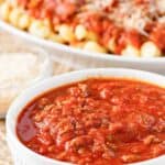Copycat Olive Garden three meat sauce in a bowl and served over pasta.