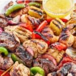Copycat Pappasito's mixed grill fajitas served with garlic butter sauce.