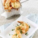 Crispy shrimp tempura in a wire serving basket and on a small plate.
