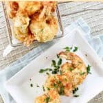 Crispy fried shrimp tempura on a plate and in a basket.