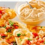 Copycat Taco Bell quesadilla sauce in a small glass bowl and drizzled on quesadillas.