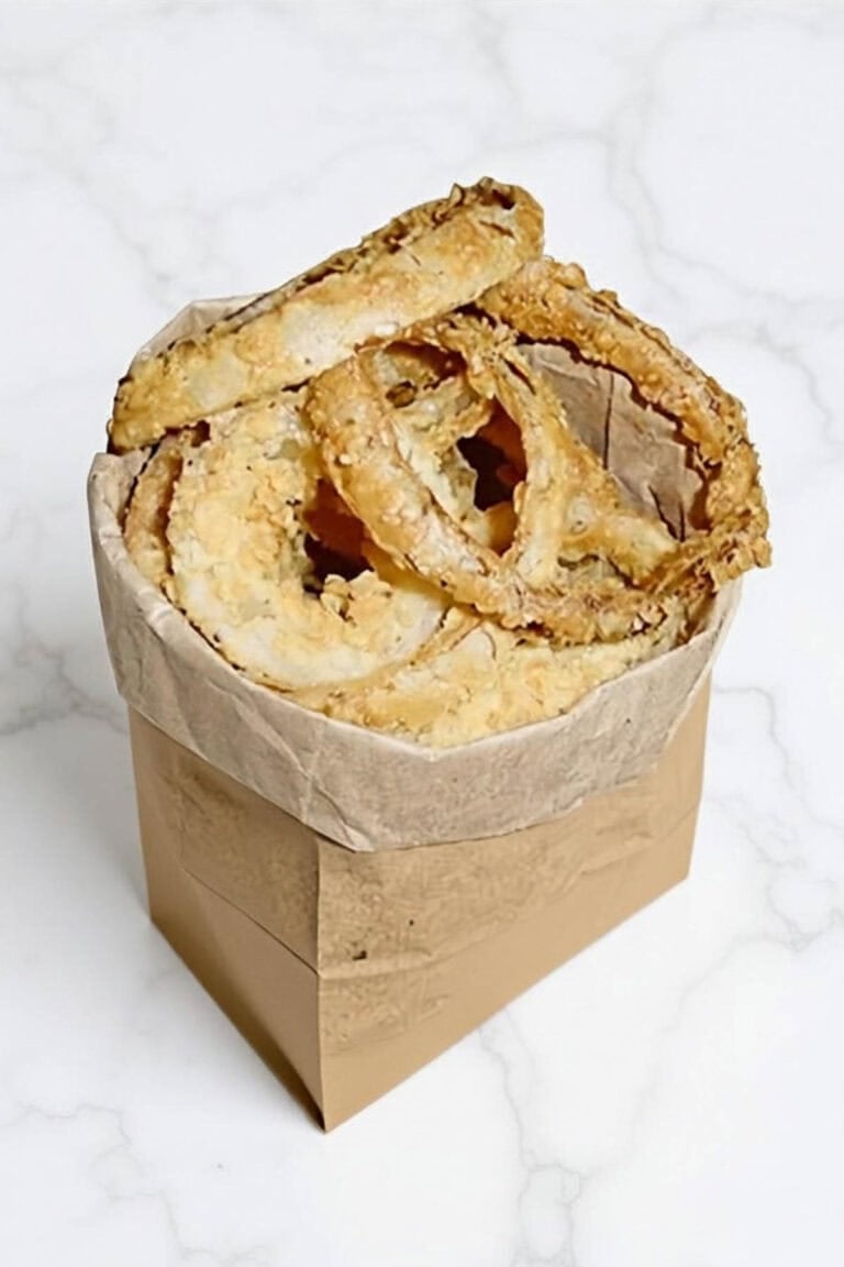 Fried onion rings in a paper bag.