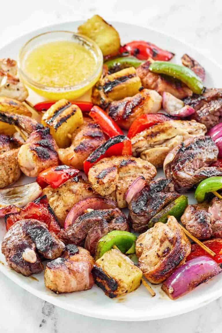 Chicken, steak, bacon-wrapped shrimp, veggie, and pineapple fajita skewers.