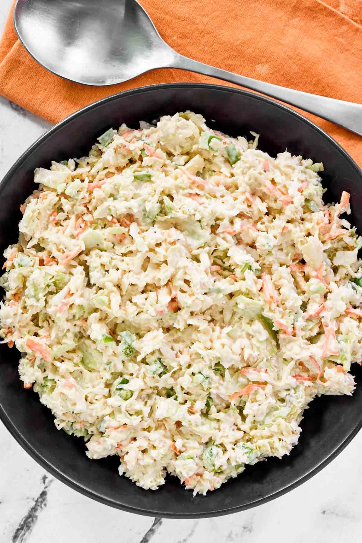 Creamy cabbage, carrot, onion, and bell pepper slaw.