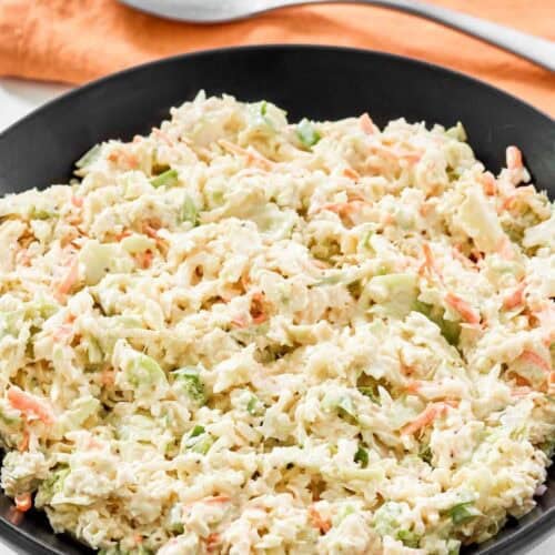 A bowl of creamy coleslaw made with cabbage and veggies.