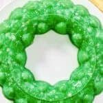 A lime gelatin salad with cottage cheese and pineapple.