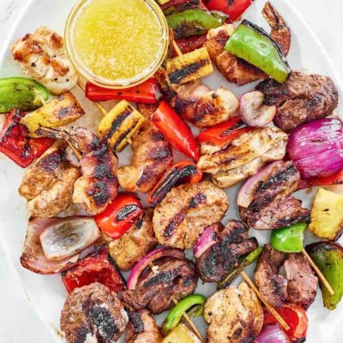 Steak, chicken, bacon-wrapped shrimp, and veggie fajita skewers.