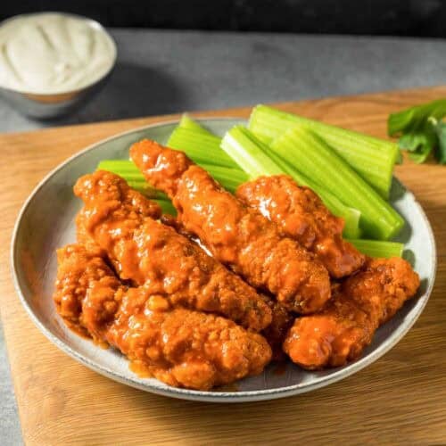 Fried chicken tenders coated in buttery hot sauce served with celery sticks and blue cheese dressing.