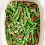 Copycat Cracker Barrel green beans with bacon and onions in a ceramic dish.