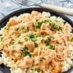 Crockpot shredded chicken and creamy gravy served over rice.