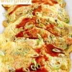 Homemade classic egg foo young with gravy on a platter.