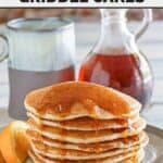 A stack of copycat IHOP country griddles cakes with syrup on a plate.
