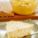 A slice of no-bake million dollar pineapple pie and a fork on a dessert plate.