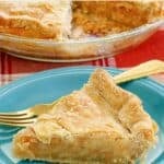 A slice of homemade mock apple pie made with Ritz crackers and a fork on a plate.