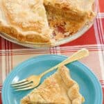 Homemade mock apple pie slice on a plate and the pie behind it.