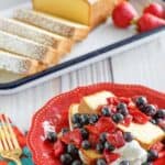 Copycat Sara Lee pound cake slices topped with berries and whipped cream.