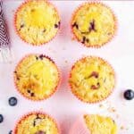 Six copycat Starbucks blueberry muffins and a few fresh blueberries.
