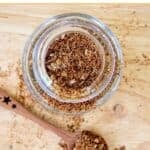 Homemade taco seasoning mix in a glass spice jar.