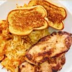 A plate of copycat Waffle House grilled chicken, hash browns, and toast.