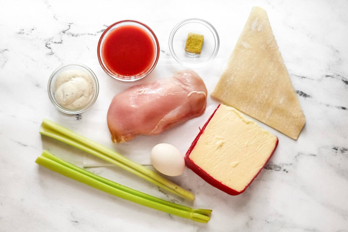Chicken, chicken bouillon, Fontina Cheese, Frank's RedHot sauce, egg, spring roll wrappers, and blue cheese dressin.