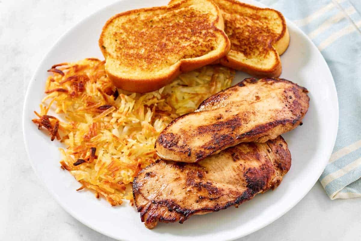 Marinated grilled chicken, hashbrown, and toast dinner.