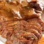 Roast beef and gravy on a platter.