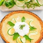 Copycat Anthony's key lime pie garnished with lime slices, mint leaves, and whipped cream.