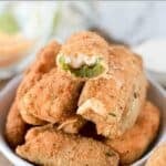 Crispy deep fried jalapeño poppers made with cheddar and cream cheese in a bowl.