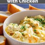 A bowl of copycat Olive Garden angry alfredo with chicken and bread slices around it.