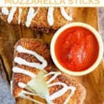 Copycat Olive Garden fried mozzarella sticks served with marinara on a wooden platter.