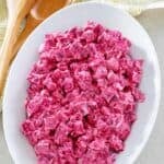 Beet salad with sour cream dressing on a platter.