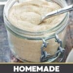 A jar of homemade vanilla sugar with a spoon in it.