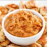 A bowl of homemade Japanese hibachi style yum yum sauce surrounded by grilled chicken pieces.