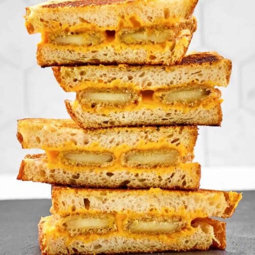 Slices of fried cheese grilled cheese sandwiches in a stack.